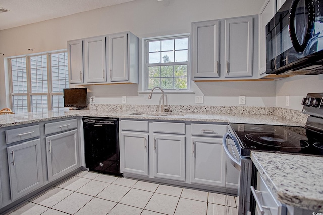 1409 Ashwood Cir, Surfside Beach, SC 29575 - kitchen with black appliances, gray cabinets, light tile patterned flooring, and light stone countertops