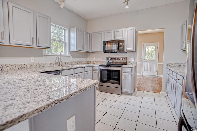 1409 Ashwood Cir, Surfside Beach, SC 29575 - kitchen featuring stainless steel range with electric cooktop, black microwave, plenty of natural light, and light stone countertops