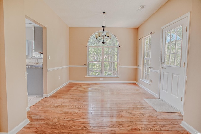 1409 Ashwood Cir, Surfside Beach, SC 29575 - foyer with light wood-style floors and a chandelier