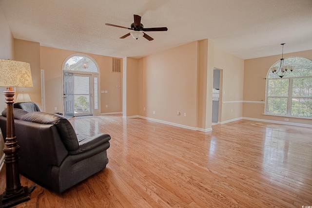 1409 Ashwood Cir, Surfside Beach, SC 29575 - living room with light wood-type flooring, ceiling fan, lofted ceiling, and a textured ceiling