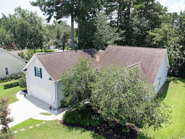 1409 Ashwood Cir, Surfside Beach, SC 29575 - view of front facade with a shingled roof, concrete driveway, an attached garage, and a front yard