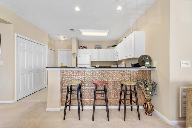 601 N Hillside Dr Unit 3926, North Myrtle Beach, SC 29582 - kitchen with white appliances, dark countertops, light carpet, and white cabinets