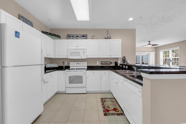 601 N Hillside Dr Unit 3926, North Myrtle Beach, SC 29582 - kitchen with white appliances, a peninsula, light tile patterned floors, dark countertops, and white cabinets