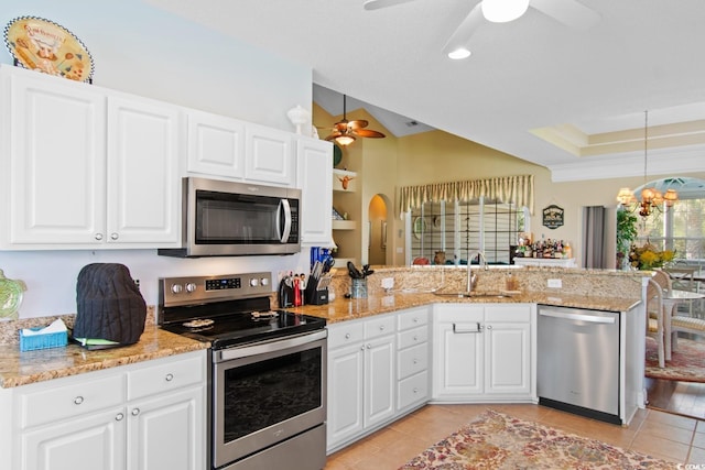 5712 Whistling Duck Dr, North Myrtle Beach, SC 29582 - kitchen with stainless steel appliances, a ceiling fan, a peninsula, light tile patterned floors, and a chandelier