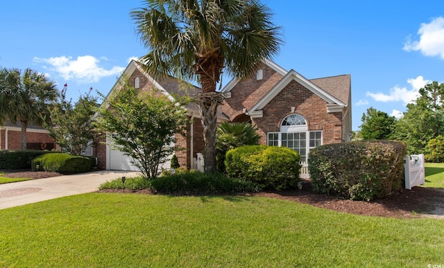 5712 Whistling Duck Dr, North Myrtle Beach, SC 29582 - view of front of home with brick siding, a front lawn, driveway, and a garage
