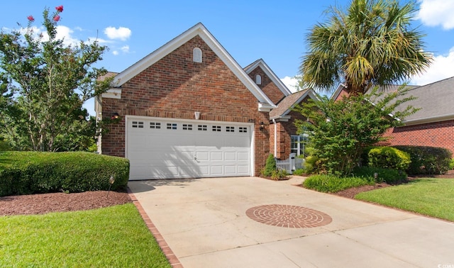 5712 Whistling Duck Dr, North Myrtle Beach, SC 29582 - view of front facade featuring brick siding, driveway, and an attached garage