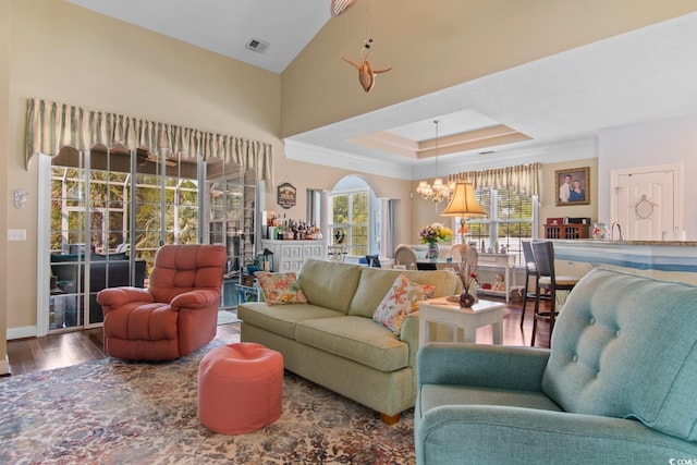 5712 Whistling Duck Dr, North Myrtle Beach, SC 29582 - living area featuring a chandelier, wood finished floors, a raised ceiling, and arched walkways