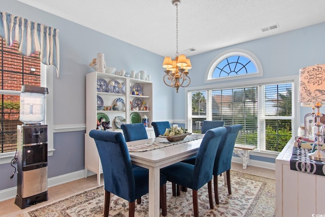 5712 Whistling Duck Dr, North Myrtle Beach, SC 29582 - dining area with a chandelier and light tile patterned floors