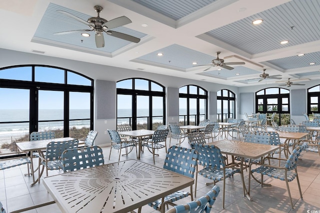 5712 Whistling Duck Dr, North Myrtle Beach, SC 29582 - dining space with a ceiling fan, light tile patterned floors, a water view, coffered ceiling, and beamed ceiling