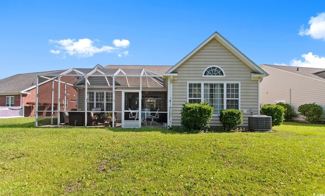 5712 Whistling Duck Dr, North Myrtle Beach, SC 29582 - back of house featuring a yard, glass enclosure, and a hot tub