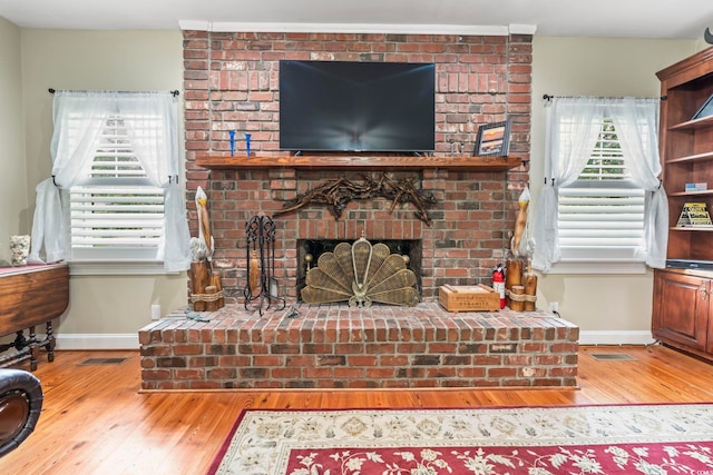 4691 Mill Pond Ct, Murrells Inlet, SC 29576 - living area featuring a brick fireplace, hardwood / wood-style floors, and plenty of natural light