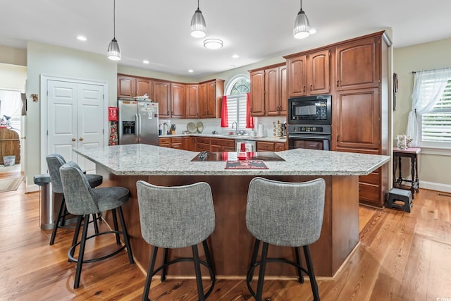 4691 Mill Pond Ct, Murrells Inlet, SC 29576 - kitchen with black appliances, light wood-style flooring, plenty of natural light, decorative light fixtures, and recessed lighting
