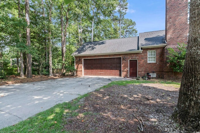 4691 Mill Pond Ct, Murrells Inlet, SC 29576 - view of home's exterior with driveway, an attached garage, brick siding, and roof with shingles