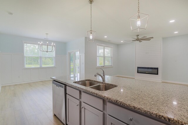 964 Irving Dr, Little River, SC 29566 - kitchen with dishwasher, plenty of natural light, a wainscoted wall, light stone counters, and ceiling fan