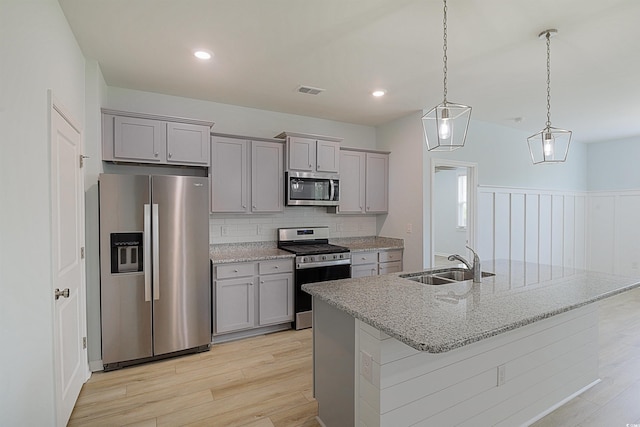 964 Irving Dr, Little River, SC 29566 - kitchen featuring appliances with stainless steel finishes, gray cabinetry, light wood-style flooring, tasteful backsplash, and recessed lighting
