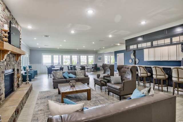 964 Irving Dr, Little River, SC 29566 - living area featuring crown molding, a fireplace, light wood-style floors, a wainscoted wall, and recessed lighting