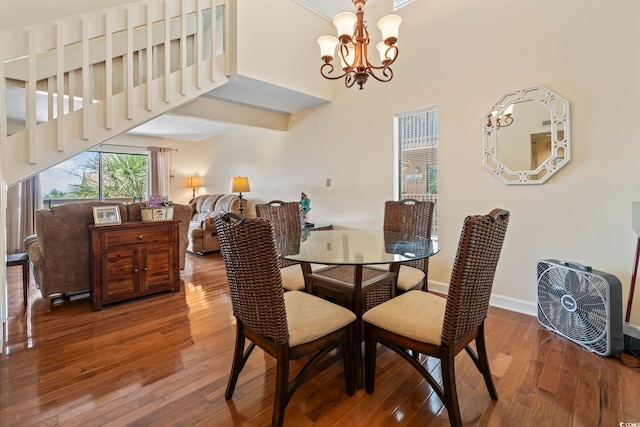 5515 N Ocean Blvd Unit 308, Myrtle Beach, SC 29577 - dining room featuring hardwood / wood-style flooring, a chandelier, and a towering ceiling
