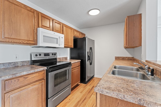 2257 Andover Dr Unit A, Surfside Beach, SC 29575 - kitchen featuring stainless steel appliances, light wood finished floors, light countertops, and a textured ceiling