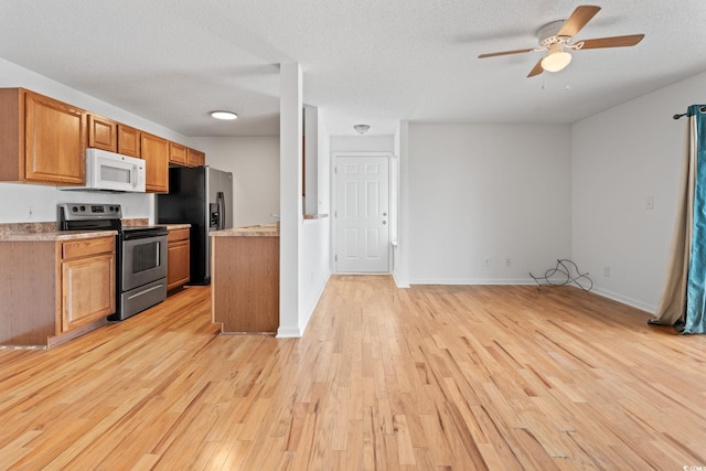 2257 Andover Dr Unit A, Surfside Beach, SC 29575 - kitchen featuring stainless steel electric stove, white microwave, refrigerator with ice dispenser, light wood finished floors, and ceiling fan