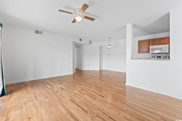 2257 Andover Dr Unit A, Surfside Beach, SC 29575 - unfurnished living room with a ceiling fan and light wood-style floors