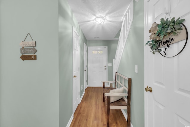 158 Palisade Loop Unit 158, Pawleys Island, SC 29585 - hall featuring light wood-type flooring, stairs, and a textured ceiling