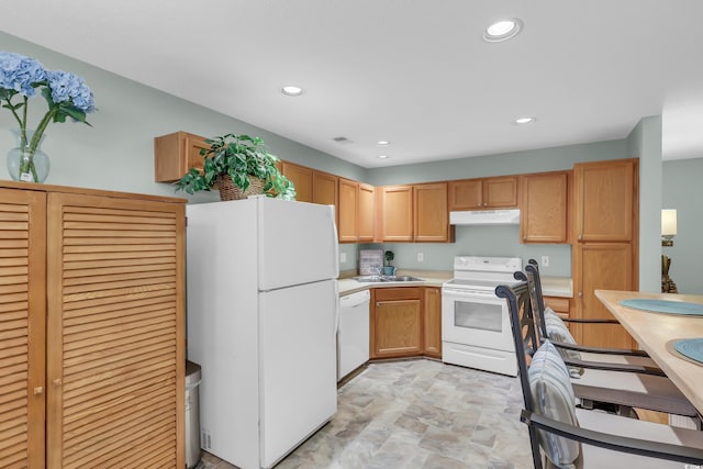 158 Palisade Loop Unit 158, Pawleys Island, SC 29585 - kitchen with white appliances, under cabinet range hood, light countertops, stone finish flooring, and recessed lighting