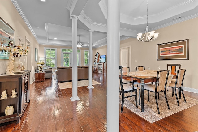 668 Barona Dr, Myrtle Beach, SC 29579 - dining room with decorative columns, a raised ceiling, dark wood finished floors, ornamental molding, and a chandelier