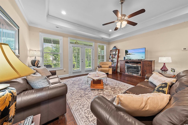 668 Barona Dr, Myrtle Beach, SC 29579 - living room featuring a raised ceiling, plenty of natural light, wood finished floors, a ceiling fan, and crown molding