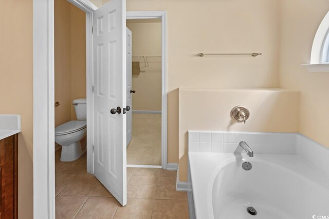 56 Willowbend Dr, Murrells Inlet, SC 29576 - full bath featuring a garden tub, a walk in closet, vanity, and tile patterned floors
