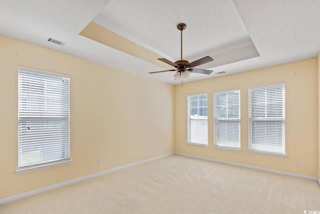 56 Willowbend Dr, Murrells Inlet, SC 29576 - spare room featuring a raised ceiling, light carpet, ceiling fan, and a textured ceiling