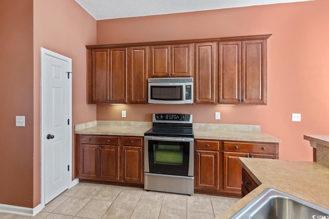 56 Willowbend Dr, Murrells Inlet, SC 29576 - kitchen with stainless steel appliances, light countertops, and light tile patterned floors