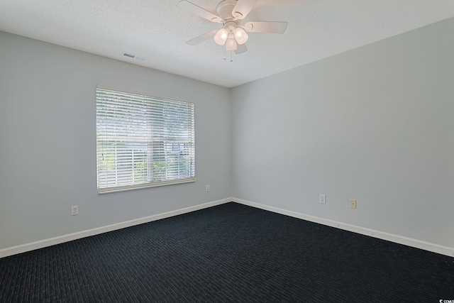 3888 Stillwood Dr, Myrtle Beach, SC 29588 - spare room featuring dark carpet, ceiling fan, and a textured ceiling