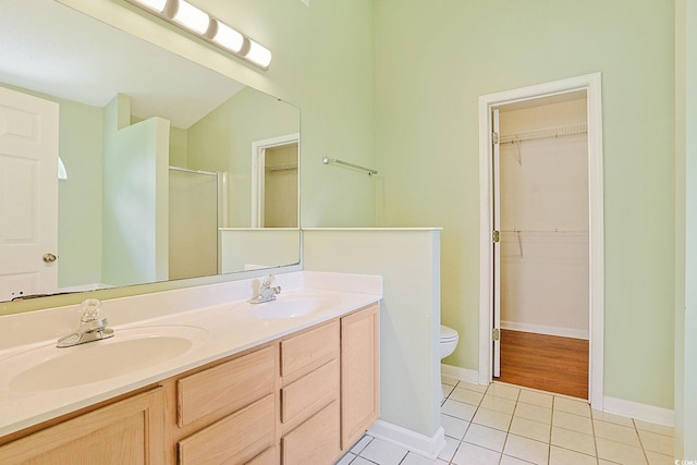 3888 Stillwood Dr, Myrtle Beach, SC 29588 - bathroom with a walk in closet, a stall shower, double vanity, and tile patterned flooring