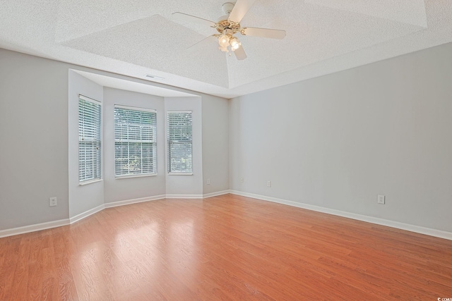 3888 Stillwood Dr, Myrtle Beach, SC 29588 - empty room featuring a textured ceiling, light wood finished floors, and a ceiling fan