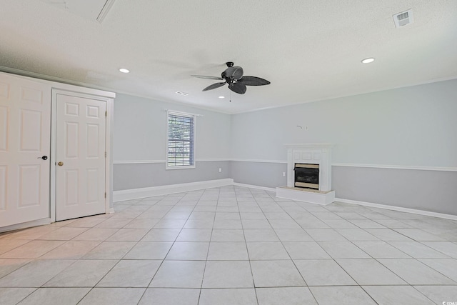 3888 Stillwood Dr, Myrtle Beach, SC 29588 - unfurnished living room featuring ceiling fan, a glass covered fireplace, recessed lighting, light tile patterned flooring, and a textured ceiling