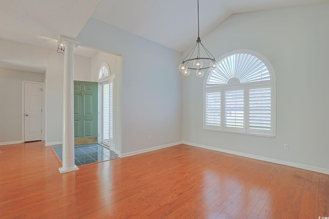 3888 Stillwood Dr, Myrtle Beach, SC 29588 - spare room featuring ornate columns, plenty of natural light, wood finished floors, lofted ceiling, and a chandelier