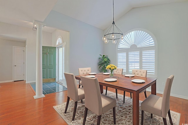 3888 Stillwood Dr, Myrtle Beach, SC 29588 - dining space with light wood finished floors, lofted ceiling, ornate columns, and a chandelier