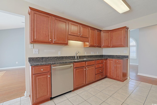 3888 Stillwood Dr, Myrtle Beach, SC 29588 - kitchen with stainless steel dishwasher, light tile patterned floors, brown cabinetry, and dark stone countertops