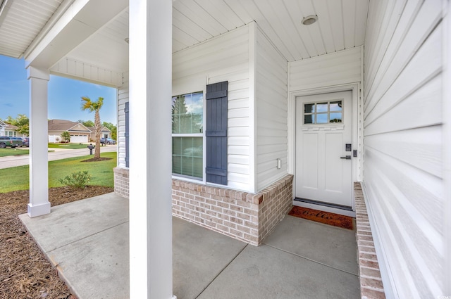 2143 Stonecrest Dr NW, Calabash, NC 28467 - doorway to property featuring a porch and brick siding