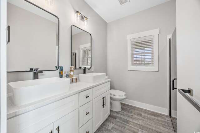2143 Stonecrest Dr NW, Calabash, NC 28467 - full bathroom with double vanity and wood finished floors