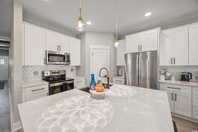 2143 Stonecrest Dr NW, Calabash, NC 28467 - kitchen featuring appliances with stainless steel finishes, tasteful backsplash, pendant lighting, and recessed lighting