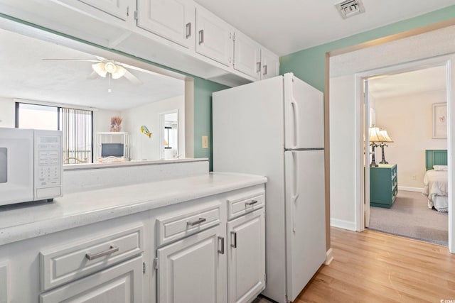 601 Mitchell Dr # 607, Myrtle Beach, SC 29577 - kitchen featuring white appliances, light countertops, white cabinets, and a ceiling fan