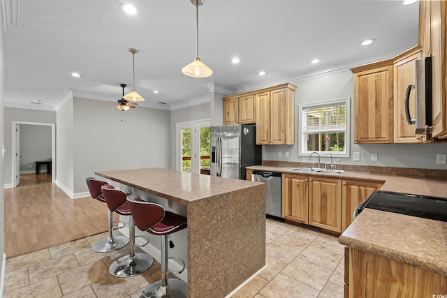 2135 Starduster Ln, Little River, SC 29566 - kitchen featuring stainless steel appliances, crown molding, recessed lighting, plenty of natural light, and a kitchen island
