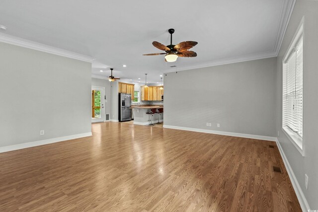 2135 Starduster Ln, Little River, SC 29566 - unfurnished living room featuring ceiling fan, ornamental molding, light wood-style floors, and recessed lighting