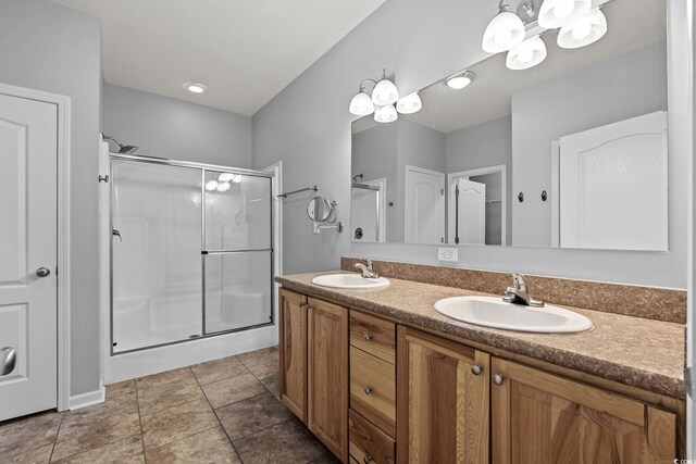2135 Starduster Ln, Little River, SC 29566 - bathroom featuring a shower stall, double vanity, and a chandelier