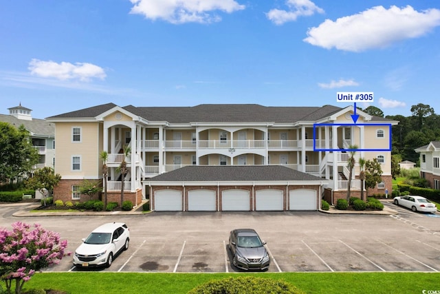 4872 Dahlia Ct Unit 305, Myrtle Beach, SC 29577 - view of building exterior with community garages and uncovered parking