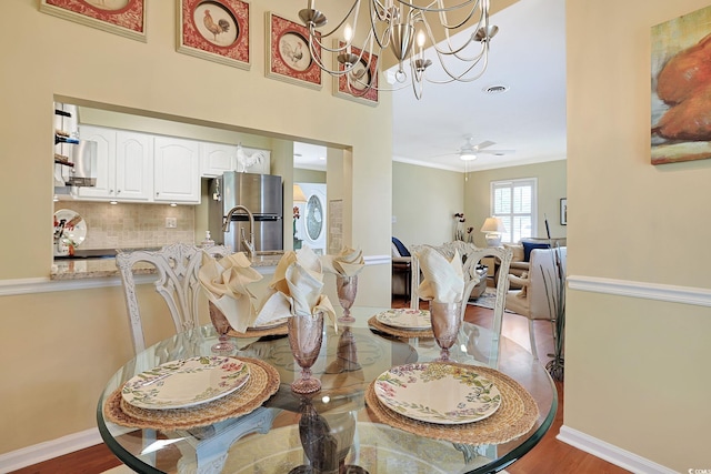 709 Jerdon Cir N, Myrtle Beach, SC 29582 - dining space with wood finished floors, a ceiling fan, a chandelier, and ornamental molding