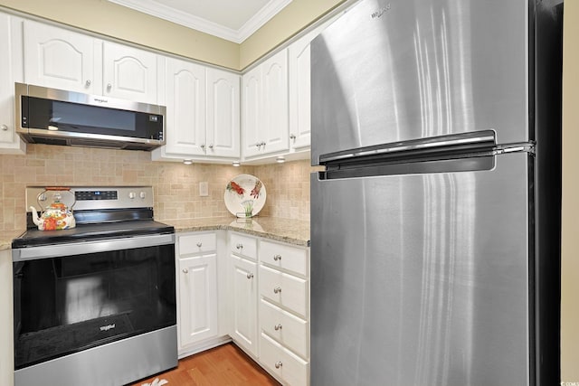 709 Jerdon Cir N, Myrtle Beach, SC 29582 - kitchen featuring stainless steel appliances, crown molding, white cabinets, decorative backsplash, and light stone counters
