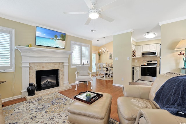 709 Jerdon Cir N, Myrtle Beach, SC 29582 - living room with crown molding, a chandelier, ceiling fan, light wood-type flooring, and a fireplace