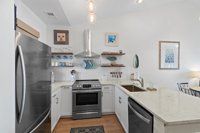 901 W Port Dr Unit 2114, North Myrtle Beach, SC 29582 - kitchen with appliances with stainless steel finishes, wall chimney exhaust hood, open shelves, and a peninsula